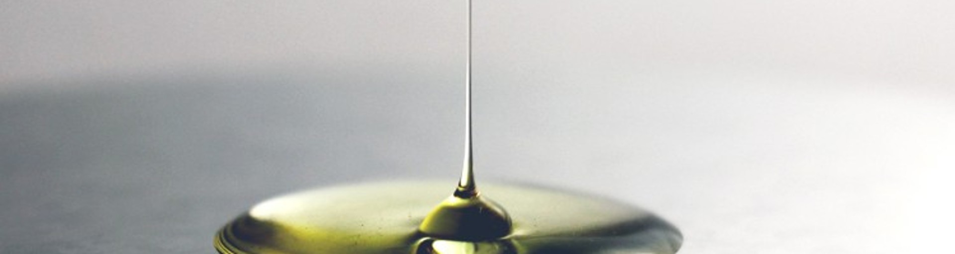 Gold-colored oil drop on black background 