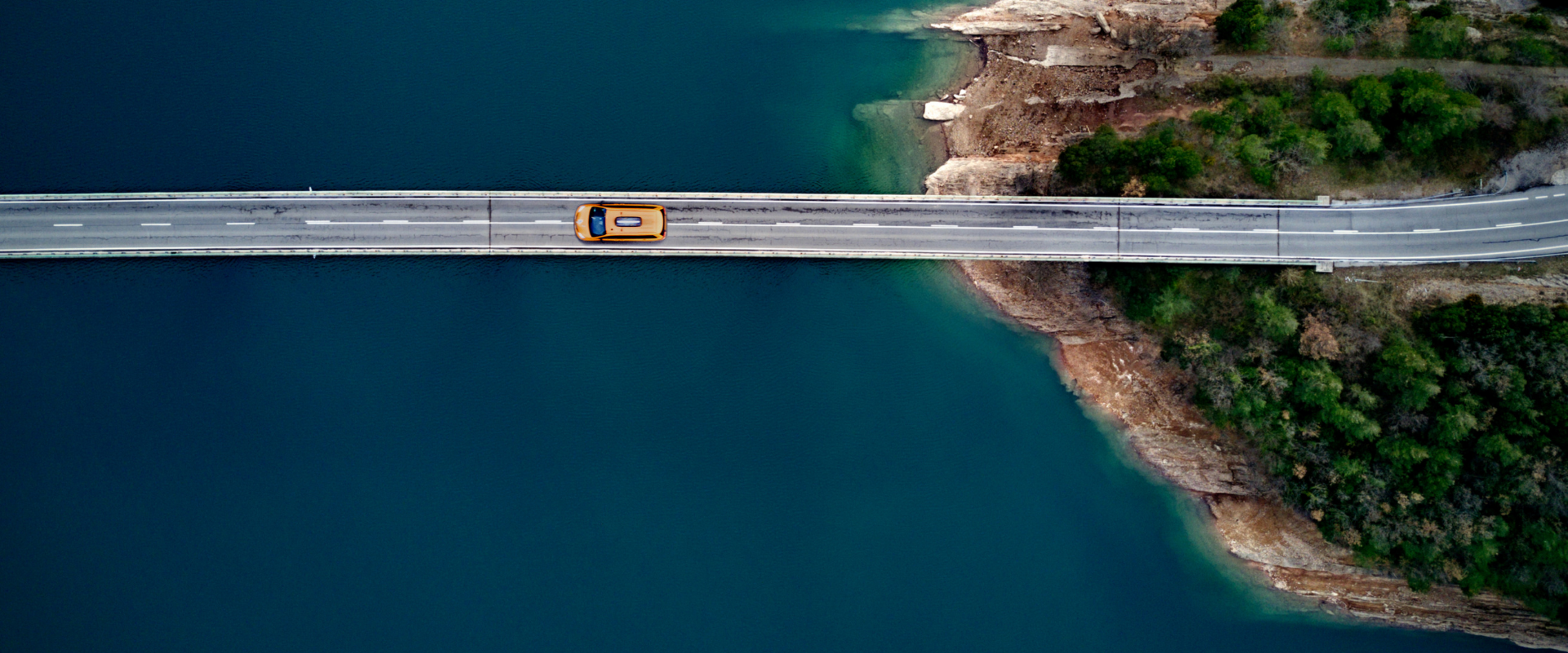 Car crossing a bridge over the water 